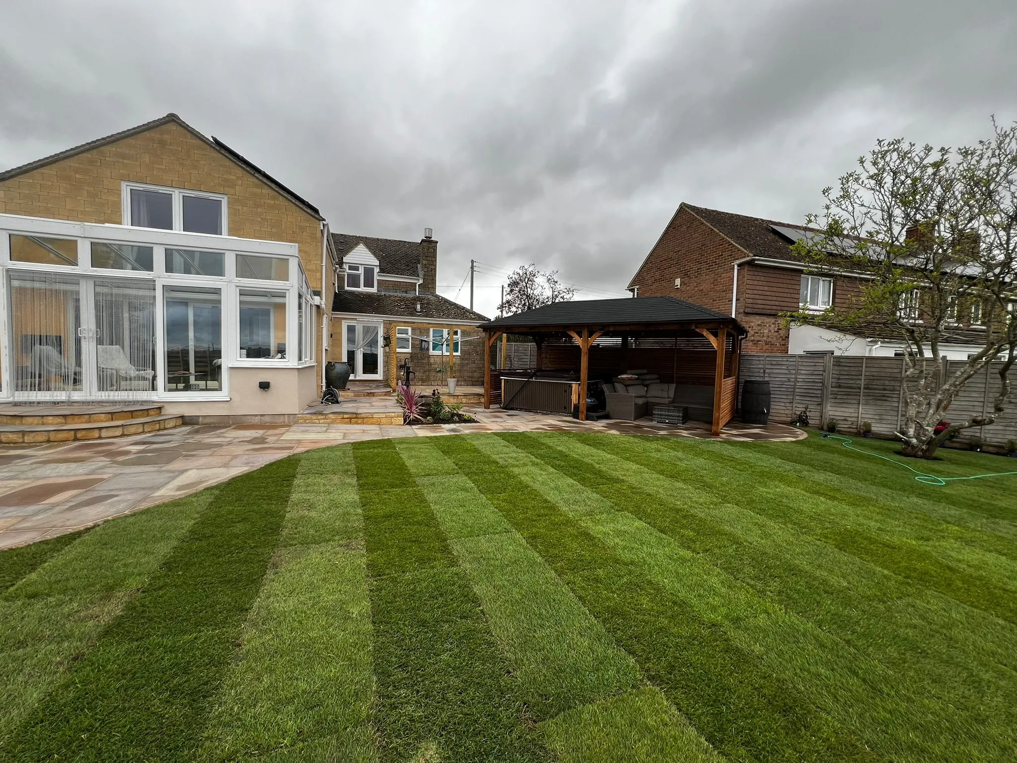 A house with a large lawn in front of it.